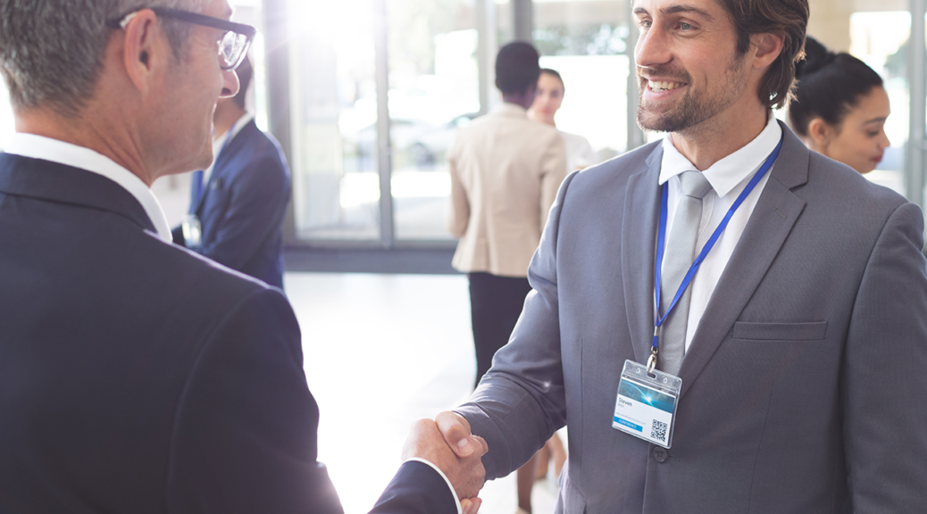 Two people shaking hands networking together.